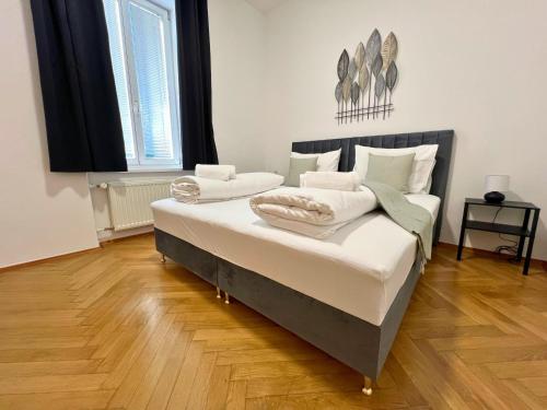 a bedroom with a bed with two pillows on it at Leoben City Apartments - Premium Apartments 24 7 in Leoben