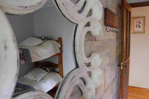 a mirror in a room with two bunk beds at Tu casa de campo en Jaca in Jaca
