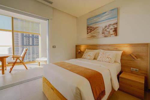 a bedroom with a large bed and a large window at Intempo by Holuxe - 024 - 2nd floor in Benidorm