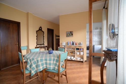 a dining room with a table and chairs at IseoLakeRental - Villa Retrò in Riva di Solto