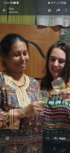 two women standing next to each other holding wine glasses at Ella Aman Vanicia Resort in Ella
