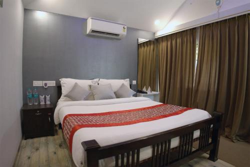a bedroom with a large bed and a window at Mystery Maze Resort and Spa in Wayanad
