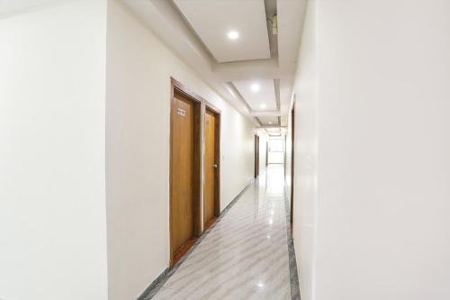 an empty corridor in a building with a door at FabHotel Raj Villa - Nr Tri mandir in Jāmb