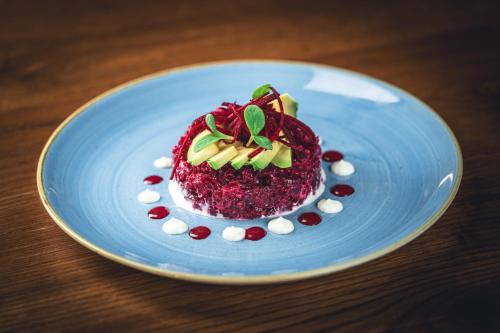 a blue plate with a dessert on a table at Hotel Jakob in Rapperswil-Jona