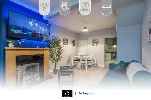 a living room with a large tv and a dining room at 2 Bedrooms House By Boyeilles Apartments Short Lets & Serviced Accommodation Belfast With Free Wifi in Belfast