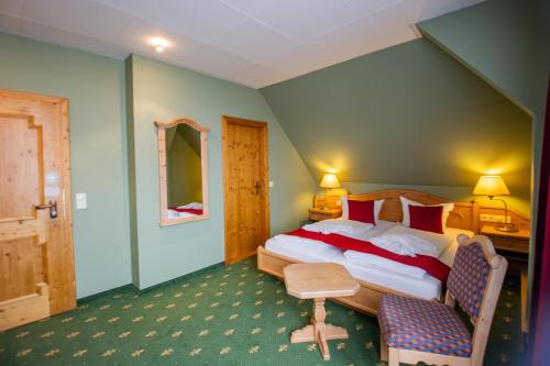 a bedroom with a bed and a table and a chair at Hotel Schloss Nebra in Nebra
