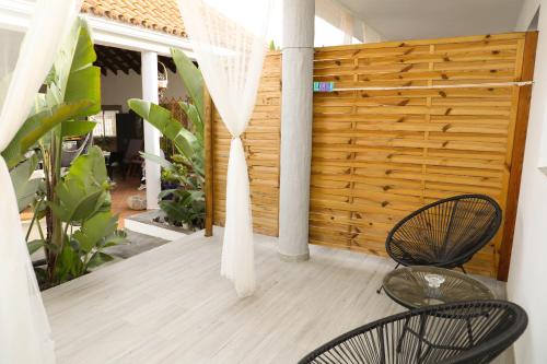 a porch with two chairs and a wooden fence at Calas De Meca in Los Caños de Meca