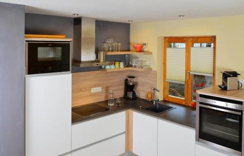a kitchen with a sink and a counter top at Haus Farbenklang in Zwiesel