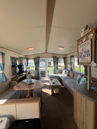 a living room with a couch and a table at Pebble Ridge hoilday home in Northam