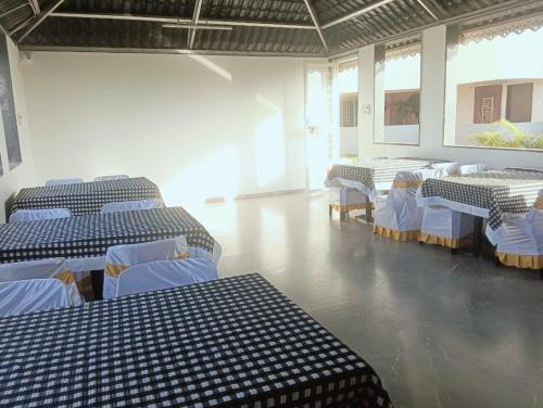 a room with blue and white tables and chairs at Hotel Vaishnavi Heights, Solapur in Bāle
