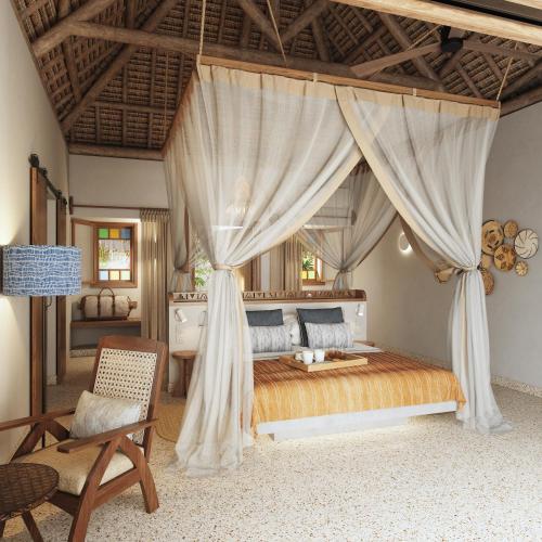 a bedroom with a bed with curtains and a chair at Matemwe Attitude - Adults Only in Matemwe