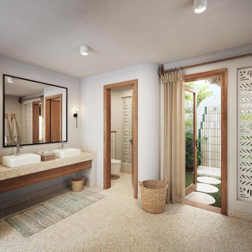 a bathroom with two sinks and a mirror at Matemwe Attitude - Adults Only in Matemwe
