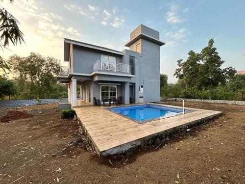a house with a swimming pool in front of it at Huvazeel Villa - Murbad for Monthly rental only in Saralgaon