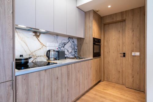 a kitchen with wood paneling and a counter and a door at Stylish Central Apartment • City Views • Prime Location • Parking in Nicosia