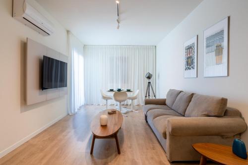 a living room with a couch and a table at Stylish Central Apartment • City Views • Prime Location • Parking in Nicosia