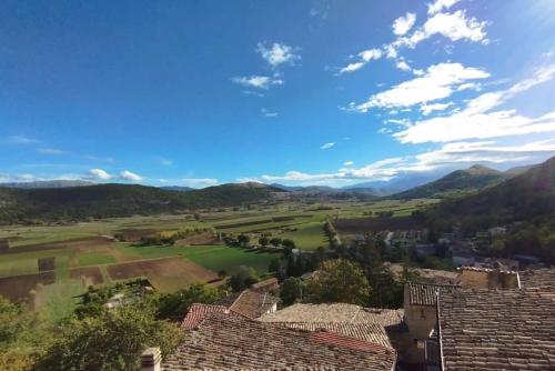 a view of a village with mountains in the background at Palazzo D'Alessandro Wunderkammer & Suites B&B di charme in Caporciano