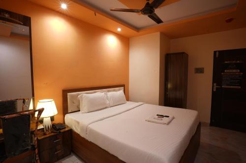 塞恩Hotel Blissful的带床和吊扇的卧室