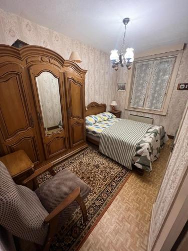 - une chambre avec 2 lits, un miroir et une chaise dans l'établissement Maison 3 chambres, à Roubaix