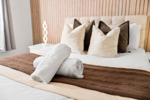 a bedroom with a bed with towels on it at Modern Four Bed House - Parking - Garden - Netflix 802W in Birmingham