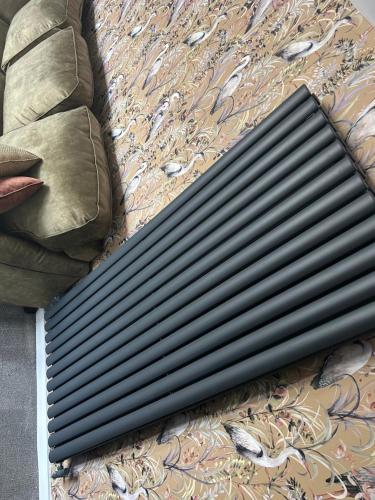 a black radiator sitting on top of a bed at Aiskew Villa Annex in Bedale