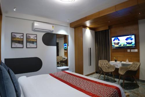 a hotel room with a bed and a television at Mystery Maze Resort and Spa in Wayanad