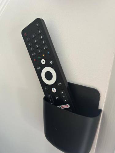 a remote control sticking out of a black holder at Aiskew Villa Annex in Bedale