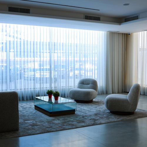 a living room with two chairs and a coffee table at BHomed Shaab in Kuwait
