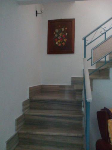 a set of stairs with a painting on the wall at LA CASA AZUL -Mancha Real, Jaen, Úbeda, Baeza- in Mancha Real