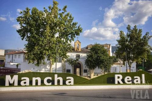 a sign in front of a large white building at LA CASA AZUL -Mancha Real, Jaen, Úbeda, Baeza- in Mancha Real