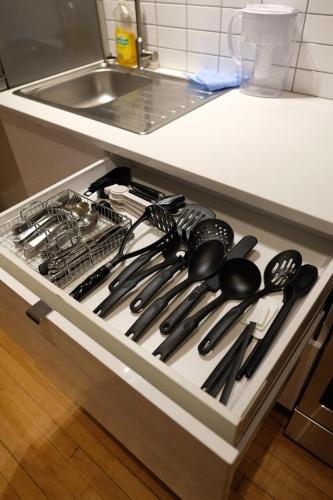 a drawer filled with lots of utensils in a kitchen at Entire Home - Downtown river trails & Remai Modern in Saskatoon