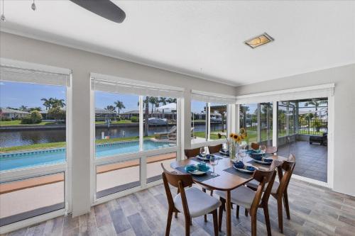 a dining room with a table and chairs and a pool at MAD510 Punta Gorda Isles in Punta Gorda