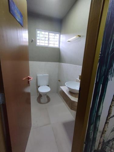 a bathroom with a toilet and a sink at Recanto da felicidade in Teresina