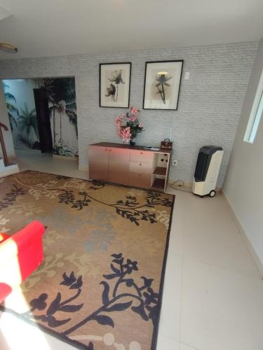 a living room with a desk and a television at Recanto da felicidade in Teresina