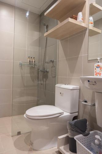 a bathroom with a toilet and a shower at The King Suite Experience in Iloilo City