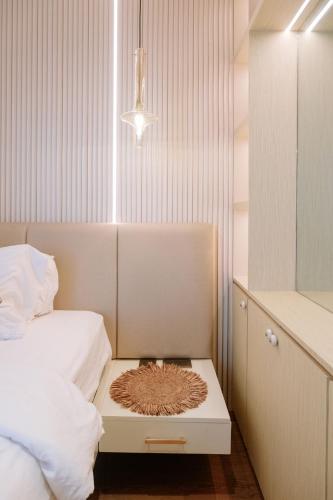 a bedroom with a bed and a table with a rug on it at The King Suite Experience in Iloilo City