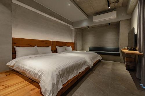 a bedroom with a large bed and a television at 全村的希望Hope of village in Dongshan