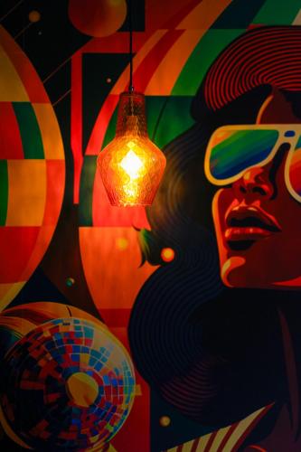 a painting of a woman with a lamp and balloons at Sleephotels 1970s in Hamburg
