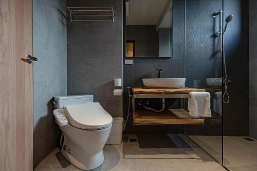 a bathroom with a white toilet and a sink at 全村的希望Hope of village in Dongshan