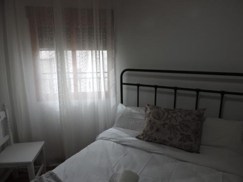 a bedroom with a bed with a pillow and a window at El Carmen in Cazorla