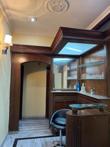 a bar in a room with a chair and a mirror at Dreams villa in Kharar