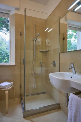 a bathroom with a shower and a sink at Hotel Emilia in Ancona