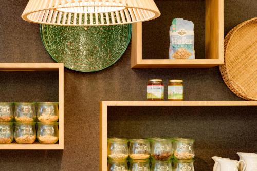 a shelf with jars of food and a green plate at Hotel Restaurant Goldener Engel in Heppenheim an der Bergstrasse