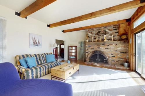 a living room with a couch and a fireplace at Bella Mare in Elk