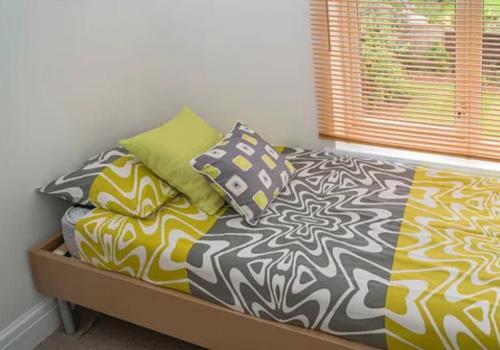 a bed with pillows on it in a room at Hotel New Kesar Palace in Agolai
