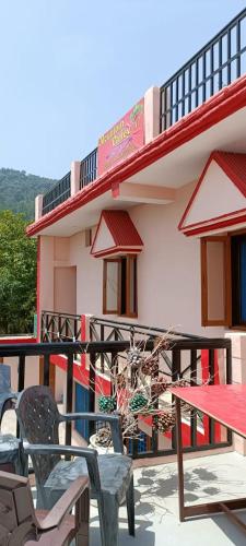 a patio with chairs and a table and a building at Mountain green valley homestay in Lansdowne