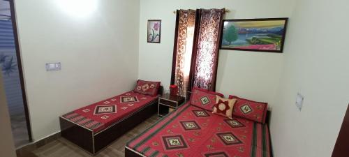 a room with two beds in a room at Mountain green valley homestay in Lansdowne