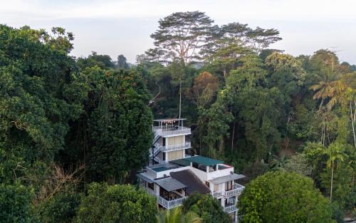 a building in the middle of a forest at Darigala House in Marapitiya