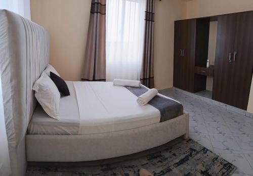 a bedroom with a large bed in a room at Apo seaview Shanzu Opposite Prideinn paradise in Mombasa