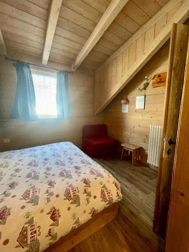 a bedroom with a bed in a log cabin at Chalet Valeruz in Canazei