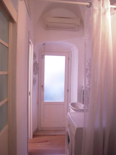 a bathroom with a window and a washing machine at Casa Santiago in Alassio